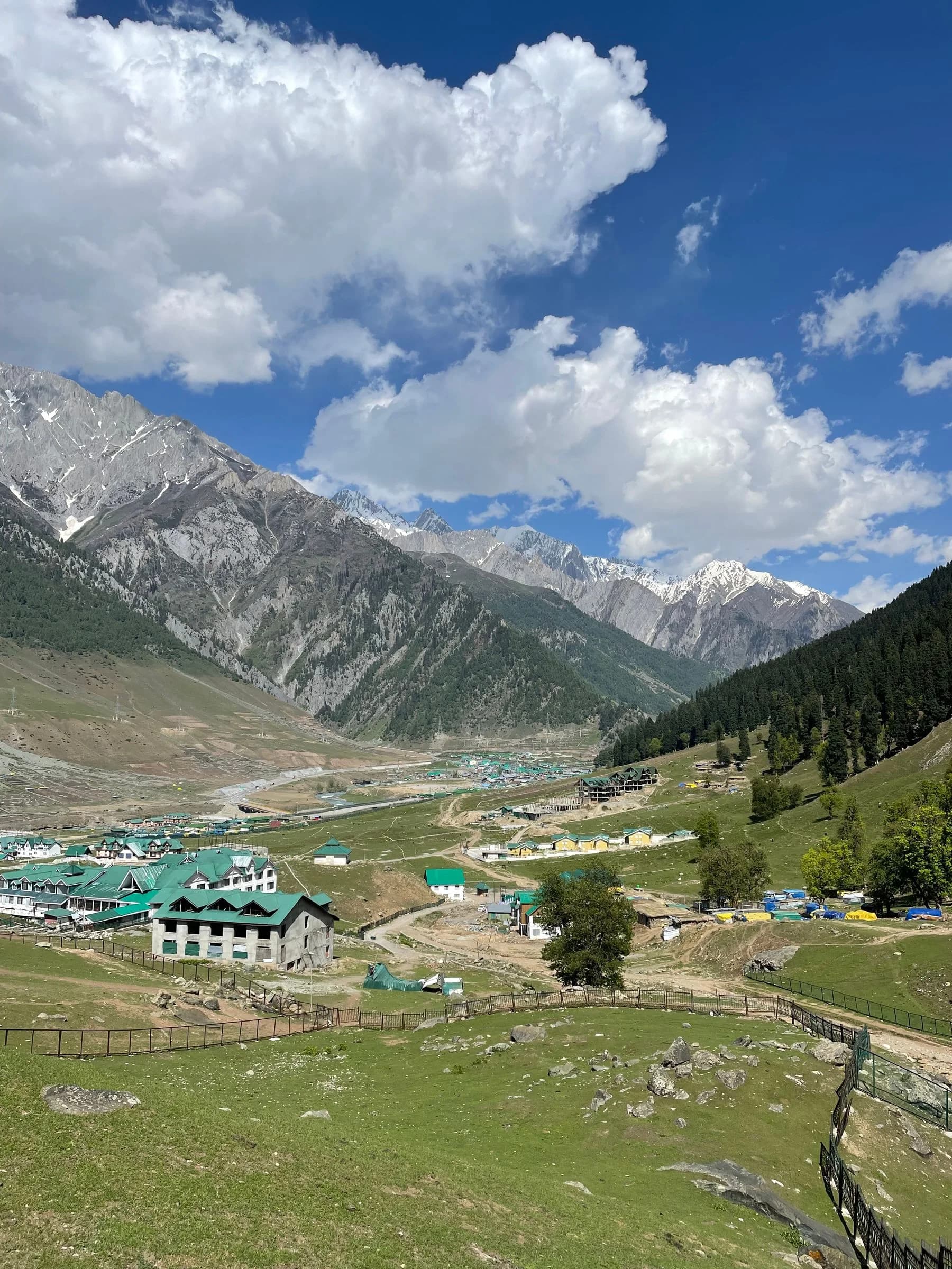 Sonamarg valley beneath rugged mountain peaks and a bright summer sky